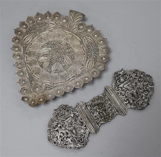 A pair oF Indian white metal buckles and a filligree work stand.